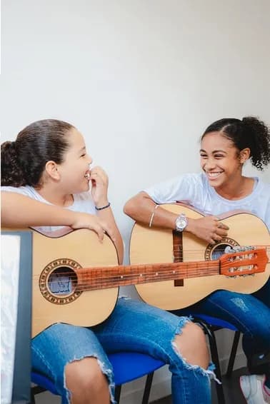 Alunas aprendendo violão